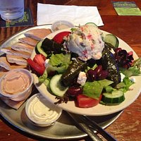Greek Salad with potato salad, hummus, and stuffed grape leaves.