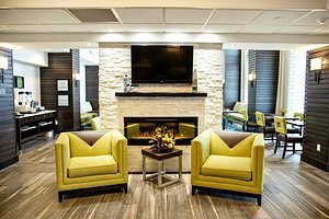 Kitchener Inn and Suites in Kitchener, image may contain: Interior Design, Living Room, Home Decor, Couch
