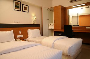 Hi 5 Hotel in Nashik, image may contain: Bed, Furniture, Bedroom, Lamp
