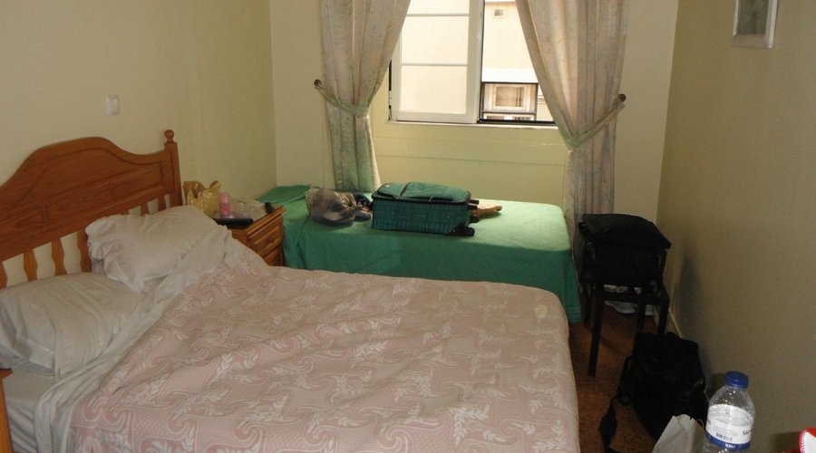 Room with one double bed and one single bed