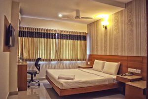 Hotel Apple Park in Coimbatore, image may contain: Interior Design, Indoors, Chair, Ceiling Fan