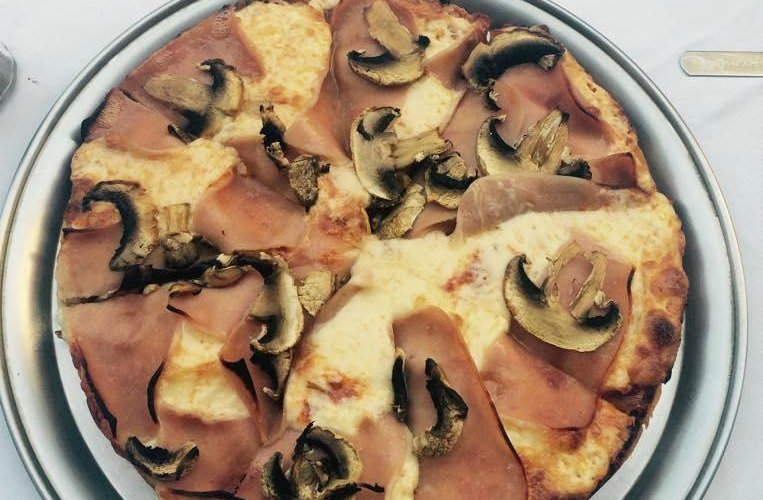 Pizza with mushrooms and hum