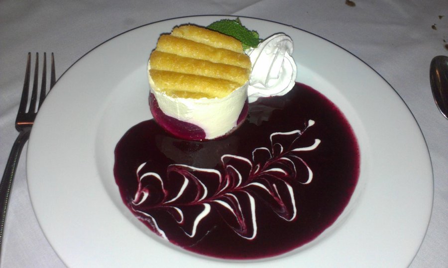 Champagne raspberry torte with berry coulis