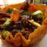 Yummy steak salad in crispy tortilla shell