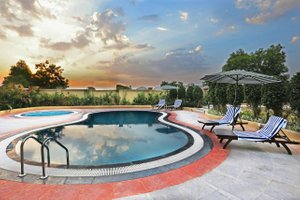 Hotel Temple Tree in Shirdi, image may contain: Resort, Hotel, Pool, Chair