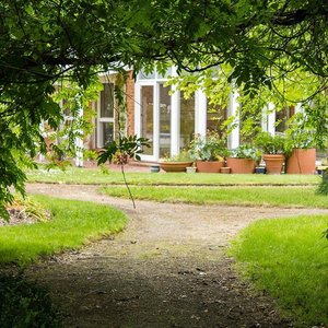 Cottage with full length windows overlooking garden