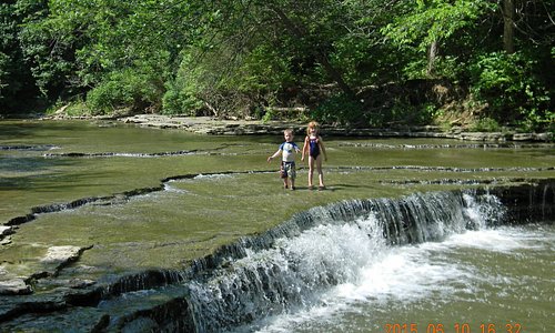 The creek is mostly flat rock bottom, up to 10" deep; waterfall pool was about 5' deep.