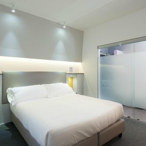 Hotel Boutique Executive Inn in Brindisi, image may contain: Couch, Furniture, Corner, Bed