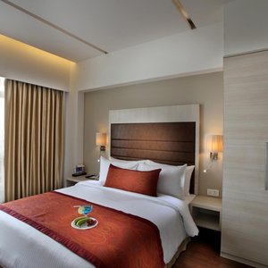 Mahagun Sarovar Portico Suites in Ghaziabad, image may contain: Lighting, Table, Furniture, Indoors