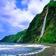 Hale Kukui's 650' waterfall in distance at end of volcanic beach