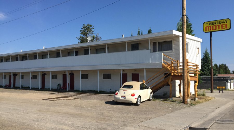 View of the outside of the hotel - gravel parking lot - pull right up to your room