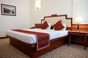 Tanyong Hotel Narathiwat in Narathiwat, image may contain: Bed, Furniture, Table Lamp, Lamp
