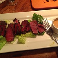 Peppered Tuna with romaine lettuce, ginger sauce and wasabi vinaigrette