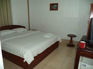 Saysamphanh Hotel in Luang Prabang, image may contain: Furniture, Bed, Cup, Bedroom