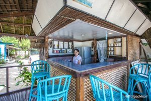MaryGold Beachfront Inn in Palawan Island, image may contain: Restaurant, Indoors, Cafe, Chair