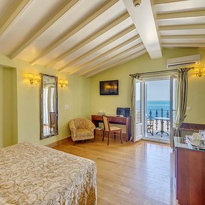 Apollonion Palace in Syros, image may contain: Penthouse, Chair, Flooring, Bed