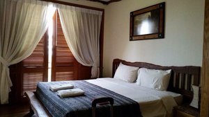 Borneo Highlands Resort in Kuching, image may contain: Bed, Furniture, Bedroom, Home Decor