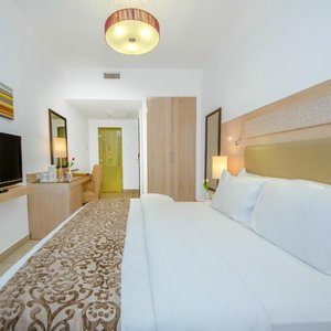 Toledo Hotel in Amman, image may contain: Couch, Furniture, Interior Design, Bedroom