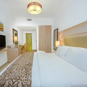 Toledo Hotel in Amman, image may contain: Couch, Furniture, Interior Design, Bedroom