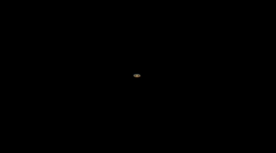 Saturn and its rings photographed through the telescope