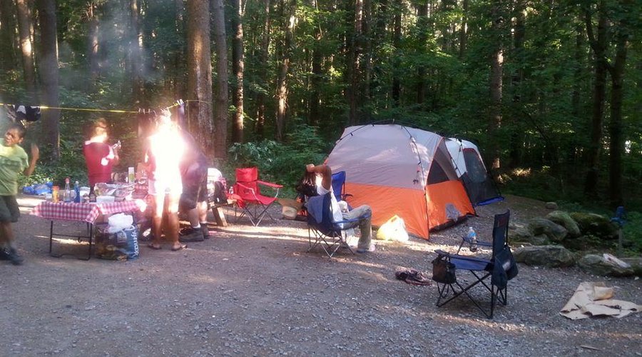 Family sitting at camp site enjoying the day