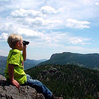 Sitting on the large rock ledge, enjoying the view