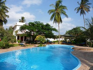 Flame Tree Cottages in Zanzibar Island, image may contain: Villa, Resort, Hotel, Summer