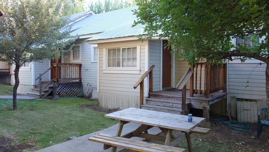 each place share a BBQ, and there are three tables in the back yard