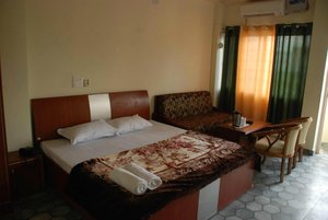 North Star Residency in Dehradun, image may contain: Bed, Furniture, Hotel, Couch
