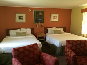 Four Winds Country Motel in Manchester, image may contain: Furniture, Bed, Bedroom, Painting