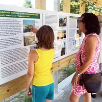 Mother and daughter check out exhibit photos