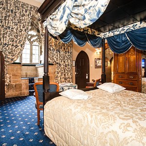 Langley Castle Hotel in Langley-on-Tyne, image may contain: Furniture, Bedroom, Indoors, Bed