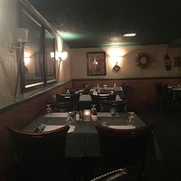 The entrance door; Down the stairs from the bar; Part of the dining room; Bread and butter start