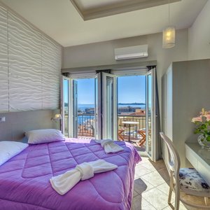 Hotel Ethrion in Syros, image may contain: Penthouse, Balcony, Bed, Lamp