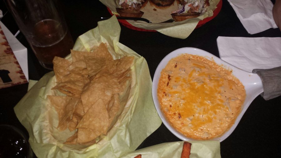 Buffalo chicken dip served with fries. Mild in spiciness, creamy base, chunks of chicken.