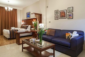 Comfort Hotel Suites in Amman, image may contain: Couch, Corner, Living Room, Home Decor