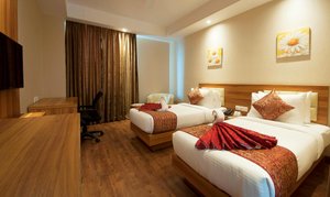 Hotel Le ROI Haridwar @ Har Ki Pauri Road in Haridwar, image may contain: Bed, Flooring, Chair, Hotel