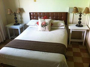 Porterville Hotel in Porterville, image may contain: Table Lamp, Lamp, Bed, Furniture