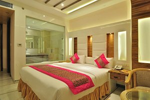 Hotel Aman Continental in New Delhi, image may contain: Interior Design, Bed, Chair, Home Decor