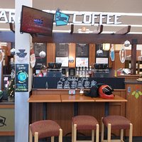 This Caribou Coffee is located in the front of this Hy-Vee Grocery Store on 212