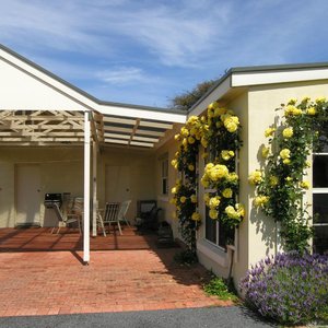 Undercover outdoor area with hooded BBQ and car parking