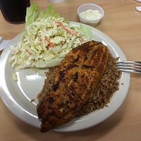 Cajun Catfish on a bed of brown rice with side of coleslaw.