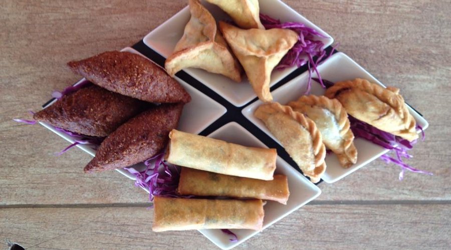 mix platter of spinach and beef patties,cheese rolls,and kibbeh balls