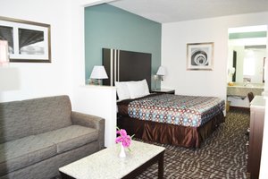Relax Inn Motel & Suites in Omaha, image may contain: Couch, Furniture, Bed, Bedroom