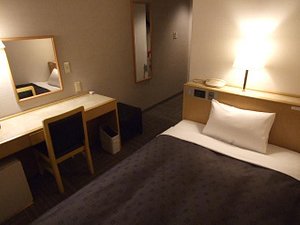 Court Hotel Mito in Mito, image may contain: Chair, Furniture, Dorm Room, Bed