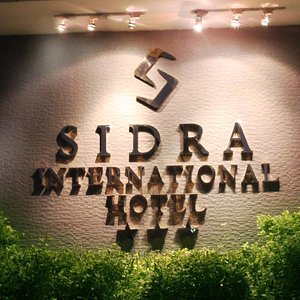 Sidra International Hotel in Addis Ababa, image may contain: Home Decor, Table Lamp, Lamp, Bed
