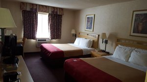 Econo Lodge in Painted Post, image may contain: Bed, Furniture, Painting, Bedroom