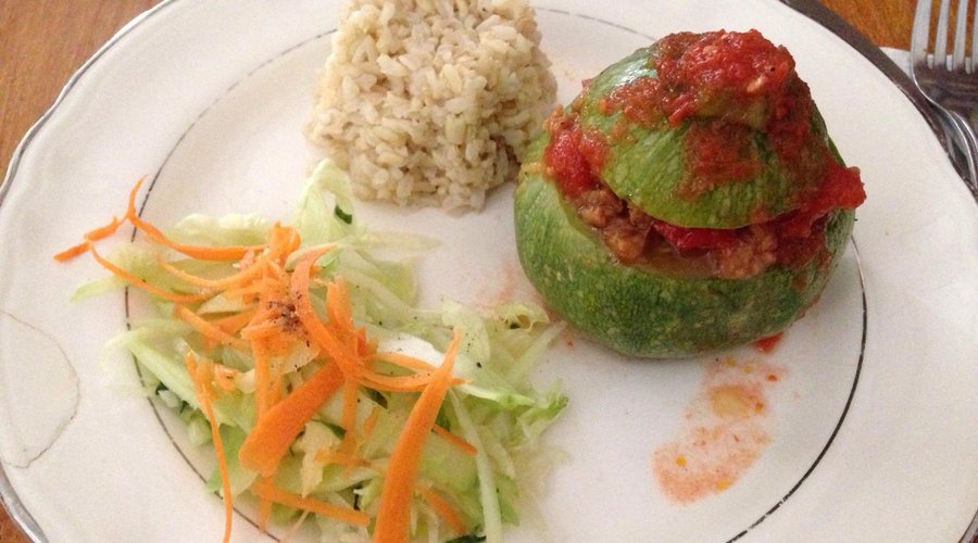 Zucchini stuffed with soy meat and salsa with brown rice. Yum!