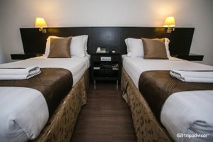 Hotel Supreme in Luzon, image may contain: Hotel, Bed, Furniture, Bedroom