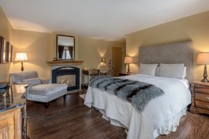 Grail Springs Retreat Centre for Wellbeing in Bancroft, image may contain: Home Decor, Fireplace, Indoors, Bed